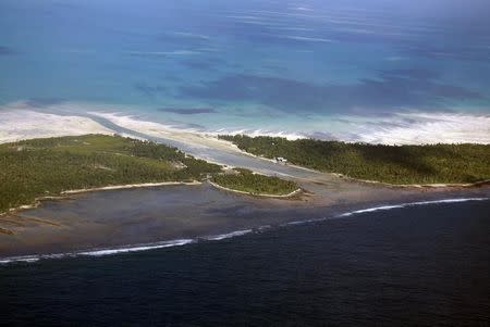 A channel runs between small areas of land on North Tarawa located in the central Pacific island nation of Kiribati May 23, 2013. REUTERS/David Gray