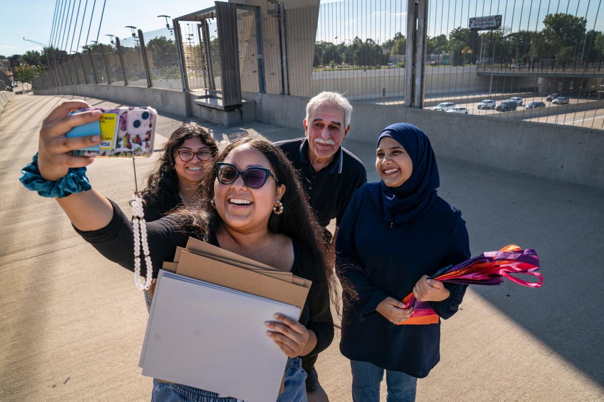 A Girl's Dream founders Ivett Facundo, 21, of Detroit, left, poses for a selfie with mentor Brianna Bryant, 21, of Detroit; Mexicantown Community Development Corporation's Executive Director Raymond Lozano and Miryim Hanek, 21, of Dearborn, Wednesday, Aug. 10, 2022 on the Bagley Street pedestrian bridge. Facundo, Bryant and Hanek hold educational supplies they will hand out as part of the after school and weekend program they started with the goal of engaging young women of color in STEAM (Science, Technology, Engineering, Arts and Math) fields. The group has made kits that include a variety of project oriented activities including paints and chia seeds etc. and clothing.