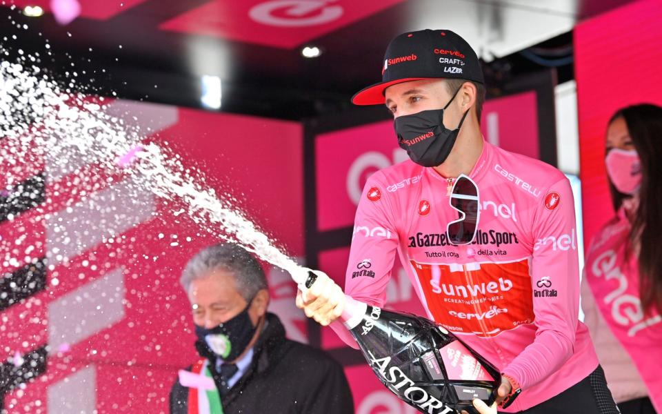 Jai Hindley celebrates remaining in the maglia rosa despite having the same time as Tao Geoghegan Hart. Will the Australian be celebrating on Sunday?  - AP