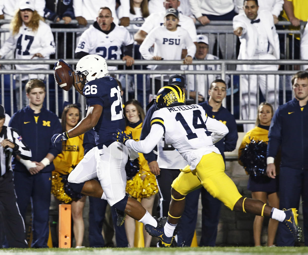 Penn State’s Saquon Barkley (26) scores a touchdown as Michigan’s Josh Metellus (14) tries to chase him down during the first half of an NCAA college football game in State College, Pa., Saturday, Oct. 21, 2017. (AP Photo/Chris Knight)