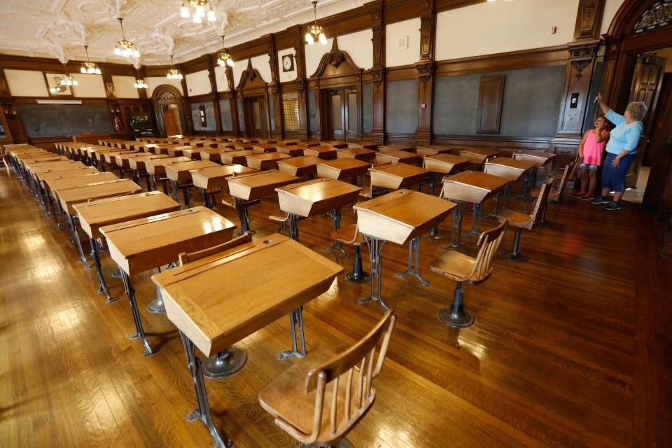 Visitors look at room 107 which at the time was considered the most beautiful classroom in the country.  Bob Foster of the Fairhaven High School Alumni Association, gives residents a tour of the historic Fairhaven High School which was donated to the town by Henry H. Rogers in 1906.