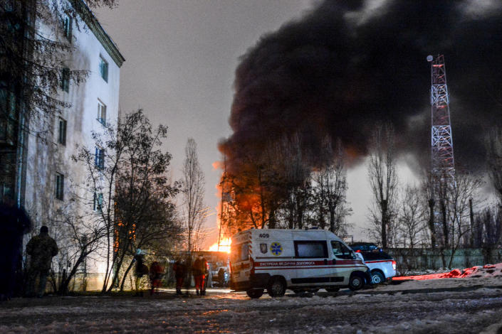 Critical power infrastructure is seen burning below a thick plume of smoke.