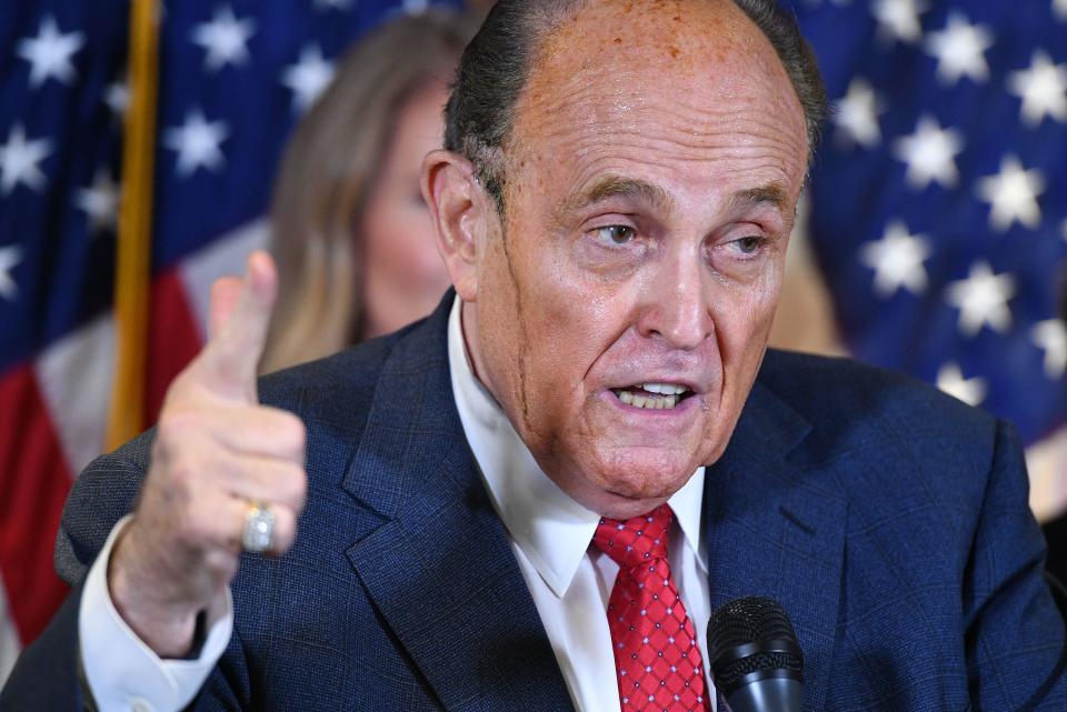 Trump's personal lawyer Rudy Giuliani perspires as he speaks during a press conference at the Republican National Committee headquarters in Washington, DC, on November 19, 2020.  / Credit: Photo by MANDEL NGAN/AFP via Getty Images