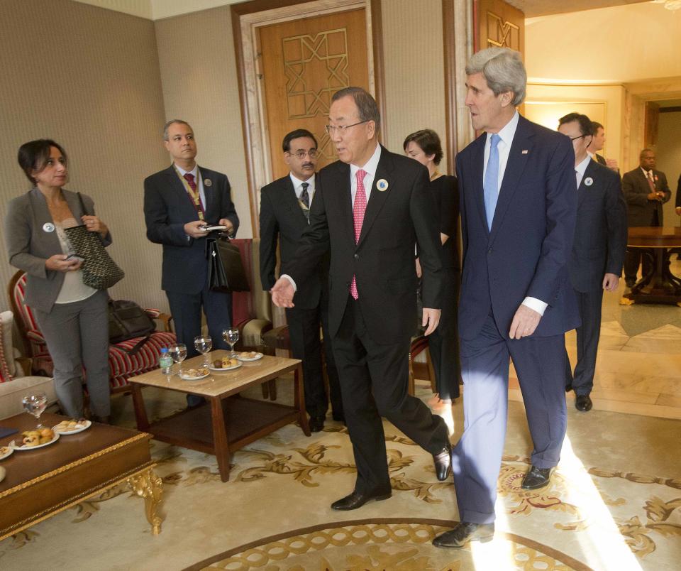 US Secretary of State John Kerry, right, walks in with UN Secretary General Ban Ki-Moon, left, before the start of their meeting at Bayan Palace in Kuwait City, Kuwait, Wednesday, Jan. 15, 2014. (AP Photo/Pablo Martinez Monsivais, Pool)