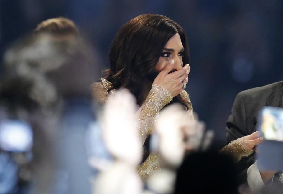 Singer Conchita Wurst representing Austria who performed the song 'Rise Like a Phoenix' holds her hand over her mouth after she is announced winner of the Eurovision Song Contest in the B&W Halls in Copenhagen, Denmark, Saturday, May 10, 2014.(AP Photo/Frank Augstein)