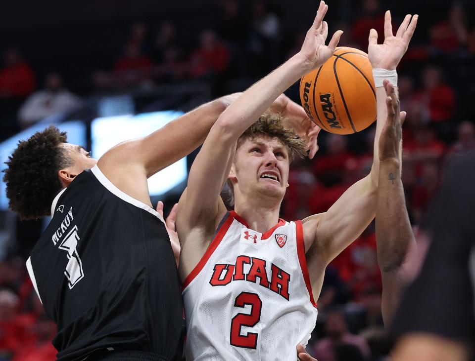 Utah Utes guard Cole Bajema (2) is fouled by Hawaii Warriors forward Justin McKoy (1) at the Delta Center in Salt Lake City on Thursday, Nov. 30, 2023. | Jeffrey D. Allred, Deseret News