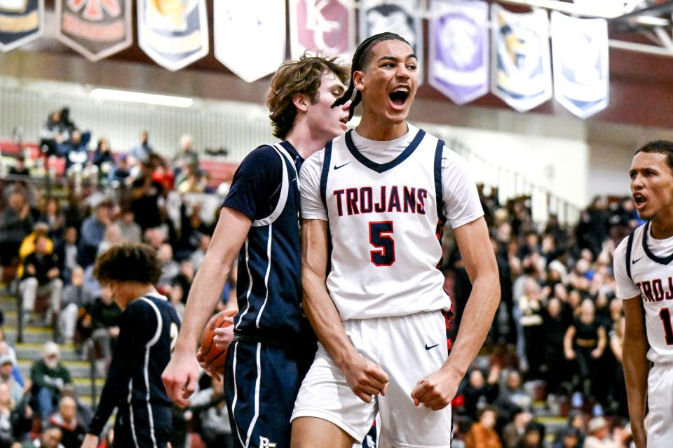 East Lansing's Cameron Hutson celebrates after scoring and drawing a Portage Central foul during the second quarter on Thursday, March 7, 2024, at Kalamazoo Central High School.