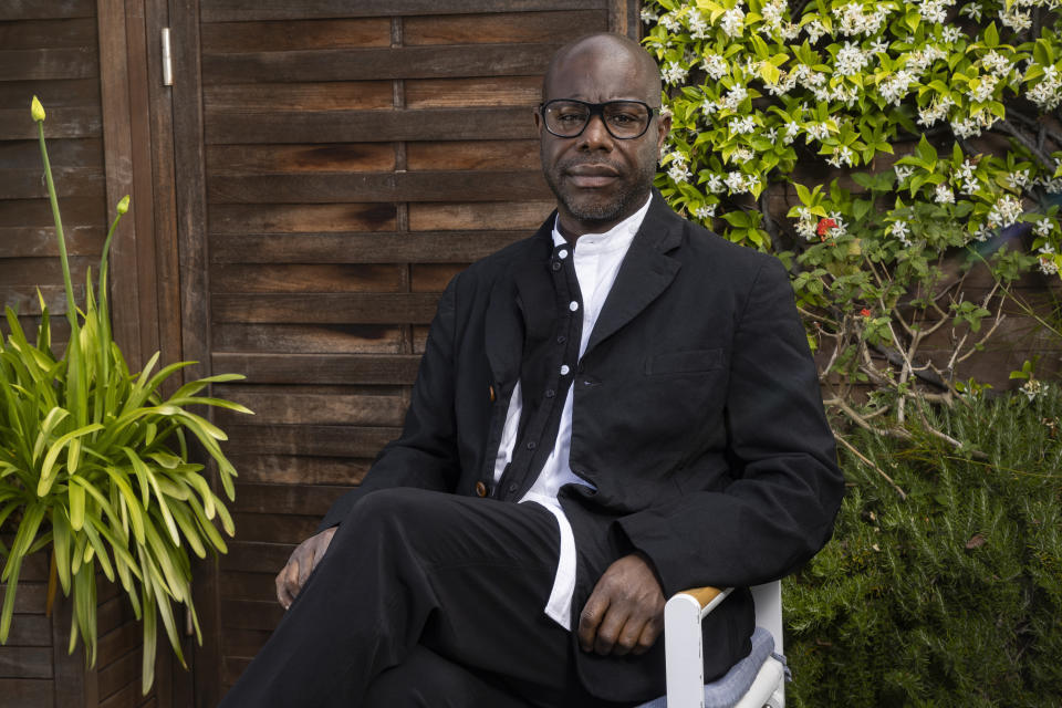 FILE - Director Steve McQueen poses for portrait photographs for the film 'Occupied City' at the 76th international film festival, Cannes, southern France, Wednesday, May 17, 2023. In McQueen’s “Occupied City,” a young woman with an even voice narrates Nazi encounters and crimes throughout Amsterdam during World War II. The accounts go address by address, while McQueen's camera visits those same places in present day. (Photo by Joel C Ryan/Invision/AP, File)