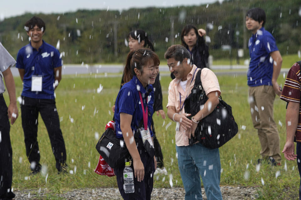 TOKYO, JAPAN - SEPTEMBER 13: Officials react to sprayed artificial snow from snow-making machines to ease heat during a canoe sprint test event for the Tokyo 2020 Olympic and Paralympic Games at Sea Forest Waterway, on September 13, 2019 in Tokyo, Japan. (Photo by Toru Hanai/Getty Images)