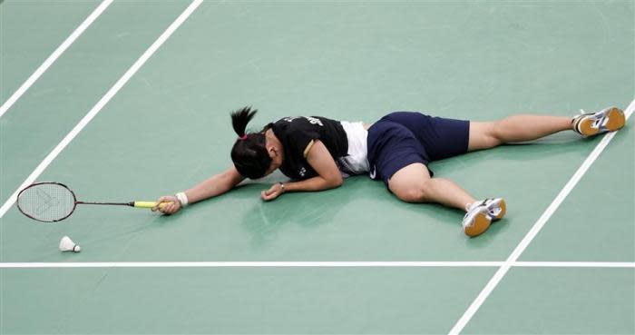 Taiwan's Tai Tzu-ying falls on the court during her women's singles round of 16 badminton match against China's Li Xuerui during the London 2012 Olympic Games at the Wembley Arena August 1, 2012.