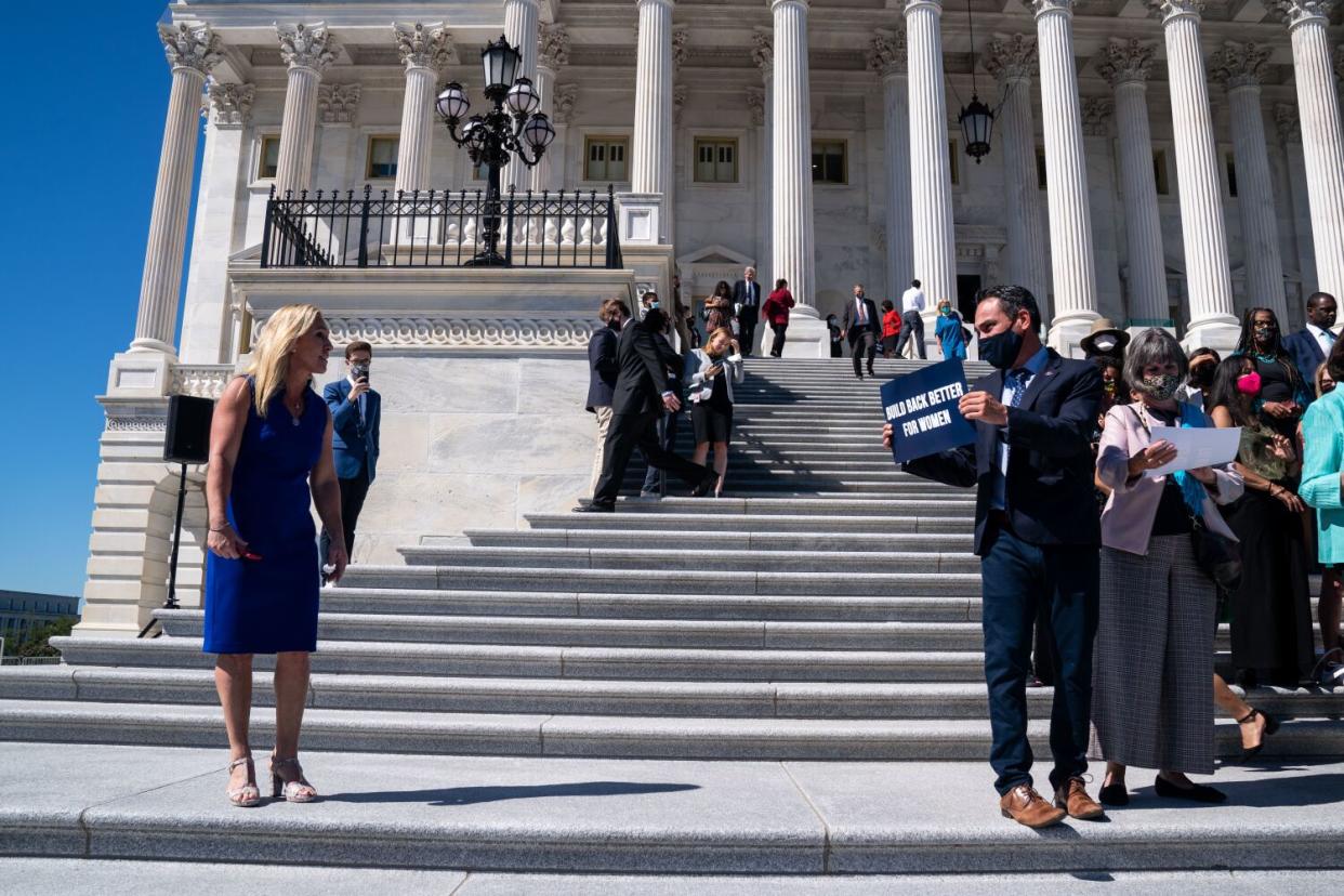 Marjorie Taylor Greene, left, exchanges words with Pete Aguilar, right, on the steps of the U.S. Capitol