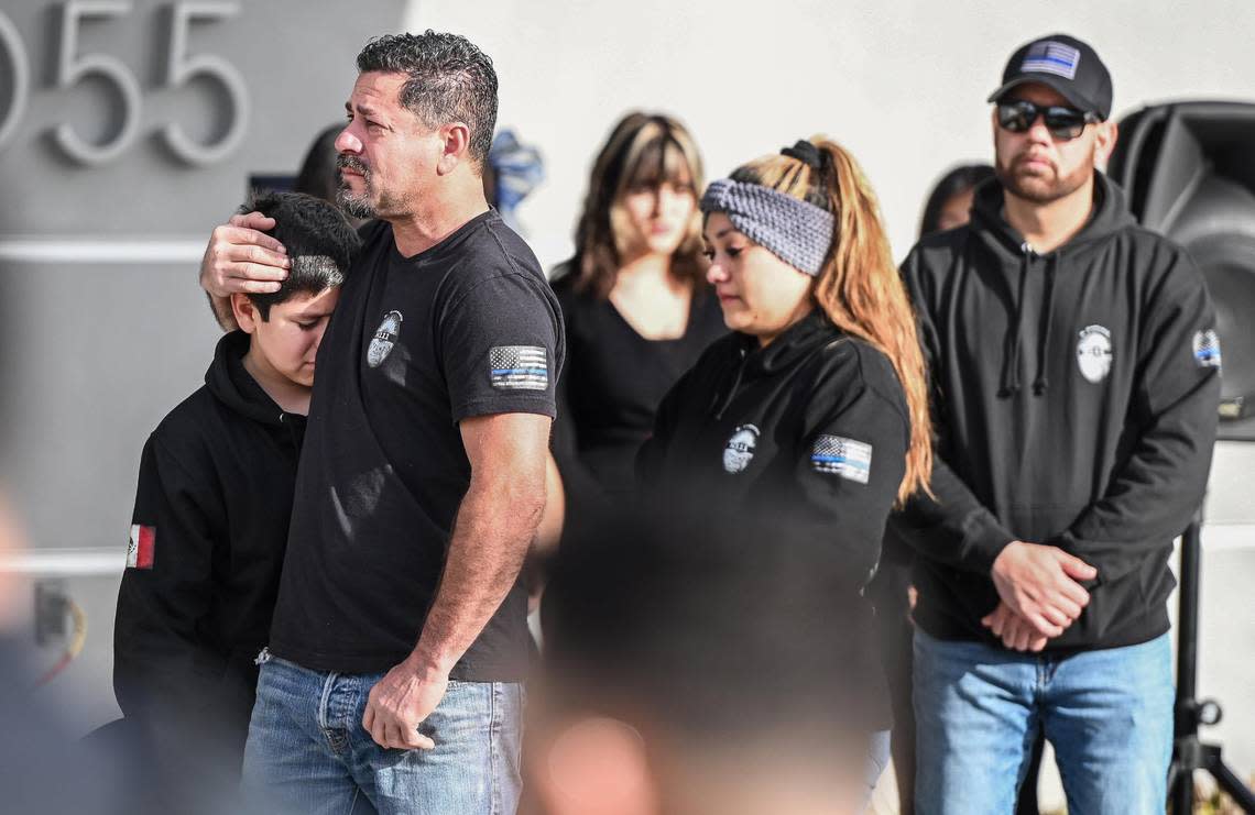 Family members watch during a service to dedicate a memorial to fallen Selma Police Officer Gonzalo Carrasco Jr. who was killed in the line of duty one year ago, at the Selma Police Department on Wednesday, Jan. 31, 2024.