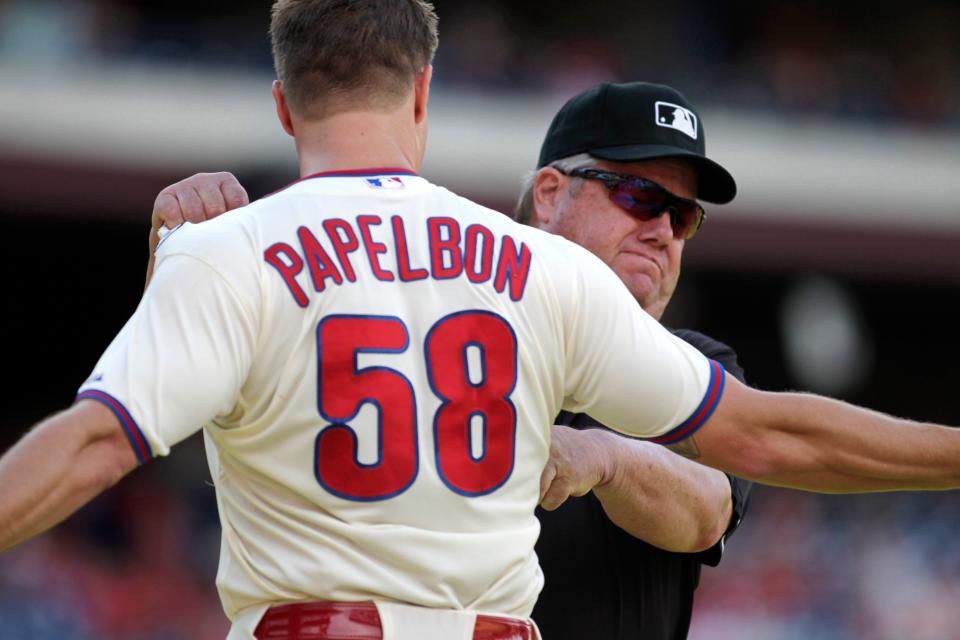 Joe West grabs Jonathan Papelbon after ejecting the Phillies pitcher from a game in 2014.