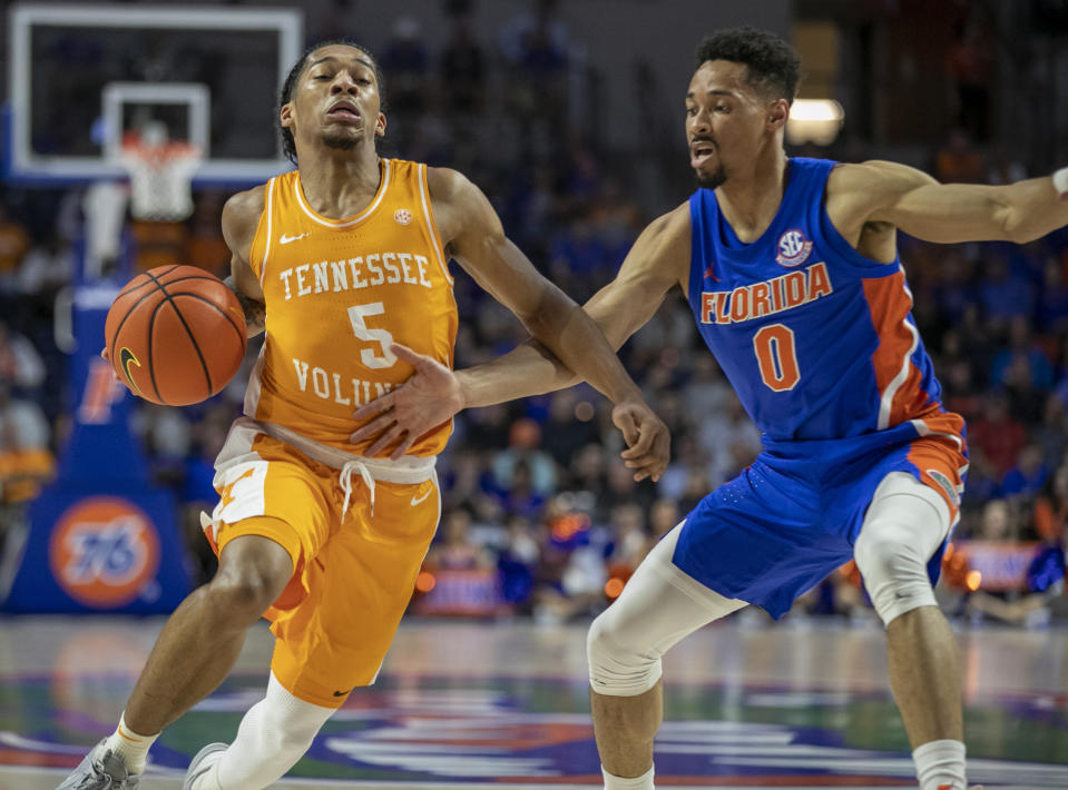 Tennessee guard Zakai Zeigler (5) drives against Florida guard Myreon Jones (0) during the first half of an NCAA college basketball game, Wednesday, Feb. 1, 2023, in Gainesville, Fla. (AP Photo/Alan Youngblood)