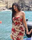 <p>With her waist-grazing hair worn loose, Kylie wore a bright red lip, white framed sunglasses and a form-fitting dress with red rose pattern. </p>