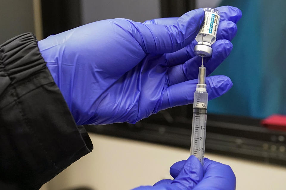 FILE — In this March 31, 2021, file photo, a nurse fills a syringe with Johnson & Johnson's one-dose COVID-19 vaccine at the Vaxmobile, at the Uniondale Hempstead Senior Center, in Uniondale, N.Y. U.S. health regulators on Tuesday, April 13, is recommending a “pause” in using the vaccine to investigate reports of potentially dangerous blood clots. (AP Photo/Mary Altaffer, File)