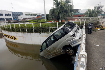 A vehicle damaged by Typhoon Hato is seen in Macau, China August 24, 2017. REUTERS/Tyrone Siu