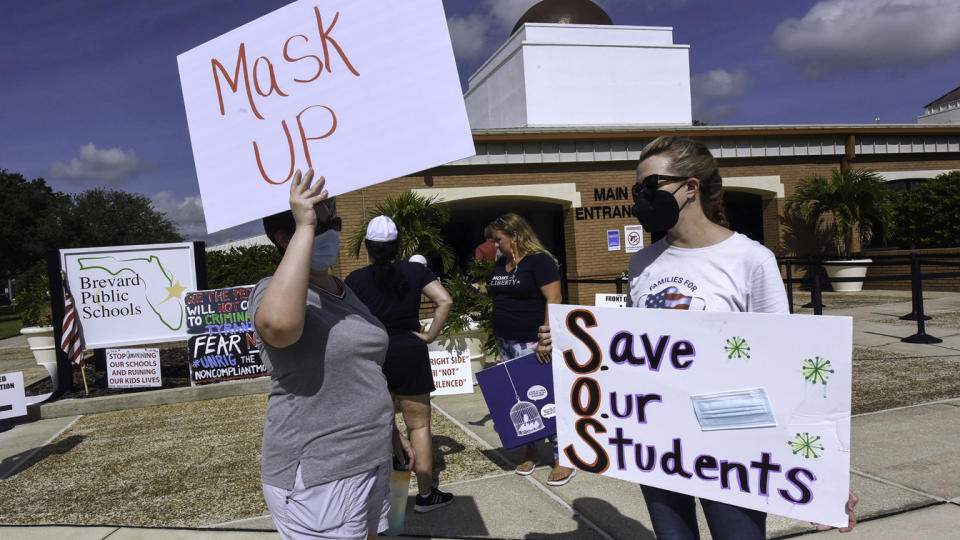 People demonstrate with placards outside an emergency meeting of the Brevard County, Florida School Board in Viera to discuss whether face masks in local schools should be mandatory. (Paul Hennessy/SOPA Images/LightRocket via Getty Images)