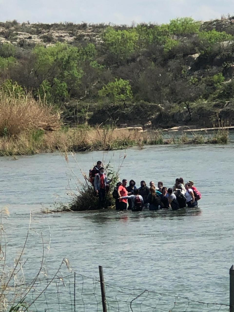 Migrants crossing the Rio Grande into Texas being rounded up by Val Verde County Sheriff deputies in April 2021.