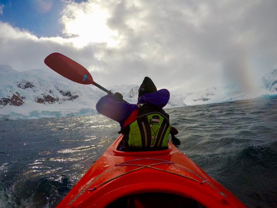 Ivor Hughes, the photographer's father, paddles a tandem kayak in the icy waters off Antartica.
