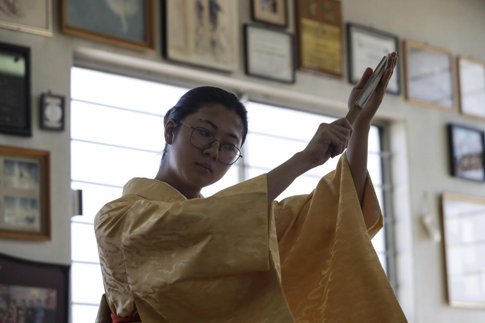 Aimi Kawasaki, a Japanese traditional Hanayagi-style dance student, practices in Professor Naoko Kihara's studio in Mexico City, Friday, Nov. 24, 2023. For traditional dancers, choreography is a sign of respect and no detail is minor. How a woman holds her fan speaks of her sense of elegance and honor. “You are not taught a dance, but a way of living,” said Kawasaki. (AP Photo/Ginnette Riquelme)
