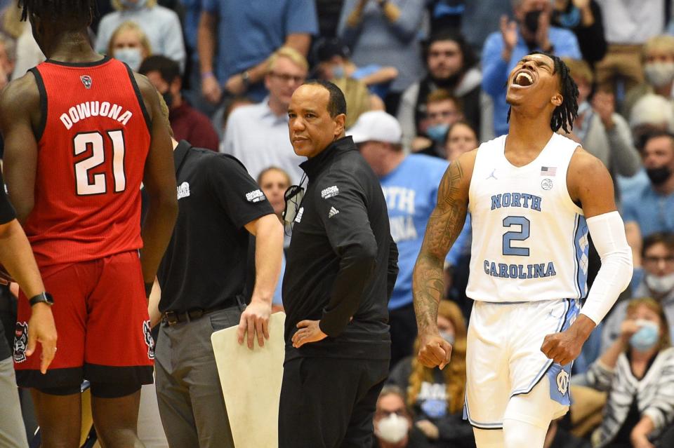 North Carolina guard Caleb Love, right, celebrates after hitting a 3-pointer as N.C. State coach Kevin Keatts calls timeout Saturday.