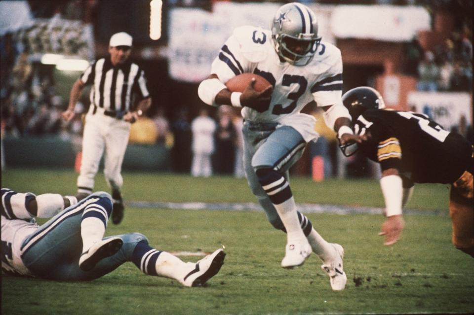 Dallas Cowboys running back Tony Dorsett (33) eludes  Pittsburgh Steelers  Tony Dungy (21) defender during Super Bowl XIII, Jan. 21, 1979. (AP Photo/file)