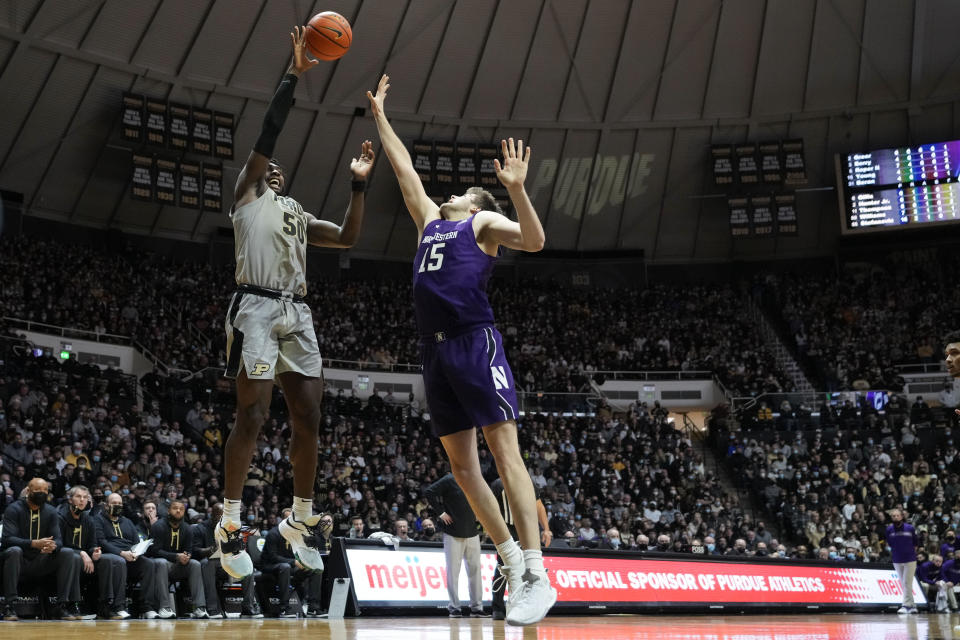 Purdue forward Trevion Williams (50) shoots over Northwestern center Ryan Young (15) in the second half of an NCAA college basketball game in West Lafayette, Ind., Sunday, Jan. 23, 2022. Purdue won 80-60. (AP Photo/AJ Mast)