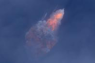 A SpaceX Falcon 9 rocket engine self-destructs after jettisoning the Crew Dragon astronaut capsule during an in-flight abort test after lift of from the Kennedy Space Center in Cape Canaveral