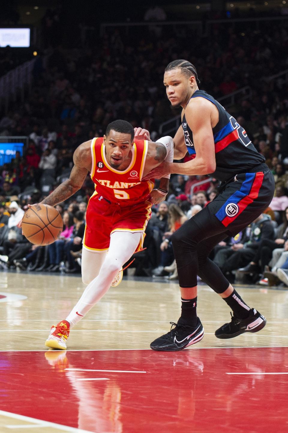 Atlanta Hawks guard Dejounte Murray drives to the basket against Detroit Pistons forward Kevin Knox II during the first half at State Farm Arena in Atlanta on Friday, Dec. 23, 2022.