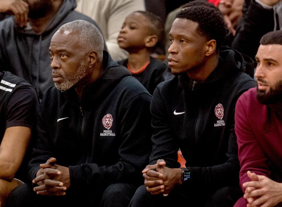 Peoria High head coach Dan Ruffin, left, and his son, assistant coach Daniel Ruffin Jr., keep an eye on the action during a game against Manual on Thursday, Feb. 6, 2020 at Manual High School.