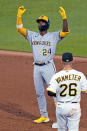 Milwaukee Brewers' Andrew McCutchen (24) celebrates as he stands on second base after doubling off Pittsburgh Pirates starting pitcher JT Brubaker during the sixth inning of a baseball game in Pittsburgh, Thursday, June 30, 2022. (AP Photo/Gene J. Puskar)