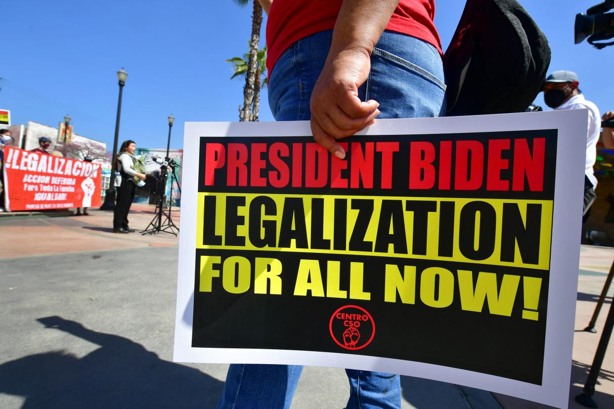 Immigrant families and their supporters attend a rally