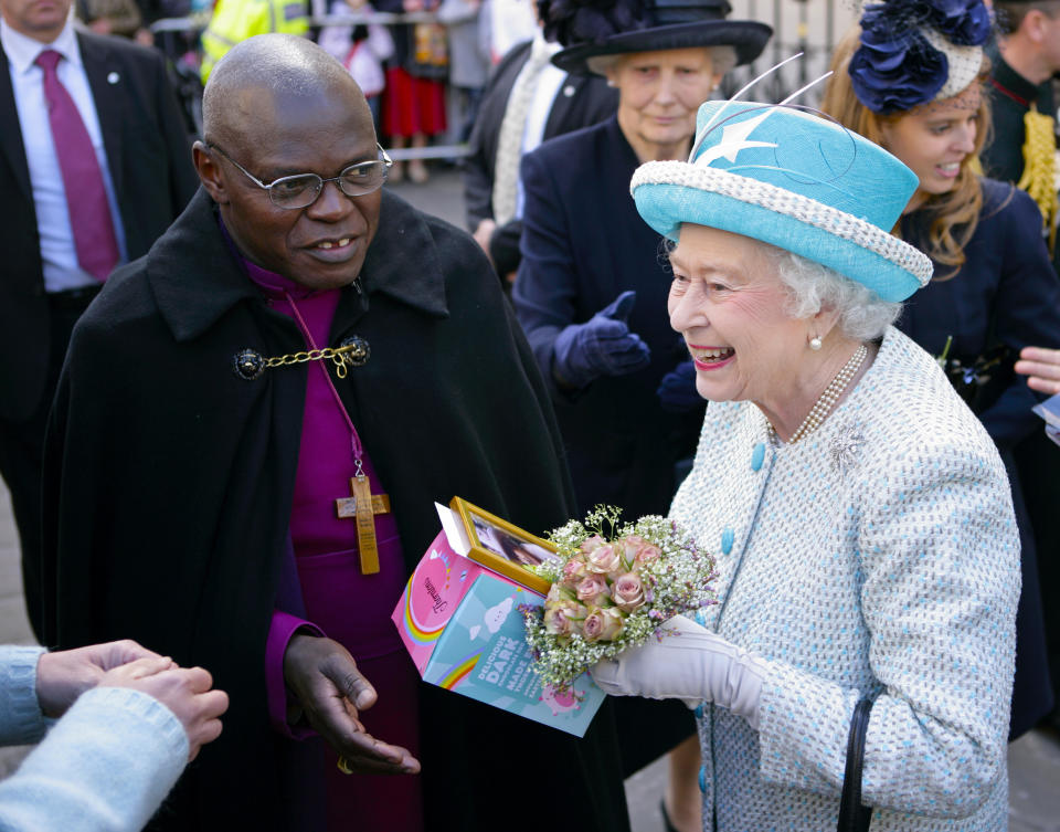 YORK, UNITED KINGDOM - APRIL 05: (EMBARGOED FOR PUBLICATION IN UK NEWSPAPERS UNTIL 48 HOURS AFTER CREATE DATE AND TIME) Queen Elizabeth II (accompanied by Dr John Sentamu, The Archbishop of York) is presented with an Easter Egg by a member of the public during a walkabout outside the Mansion House whilst on a visit to York, after attending the Maundy Thursday Church Service at York Minster on April 5, 2012 in York, England. (Photo by Indigo/Getty Images)