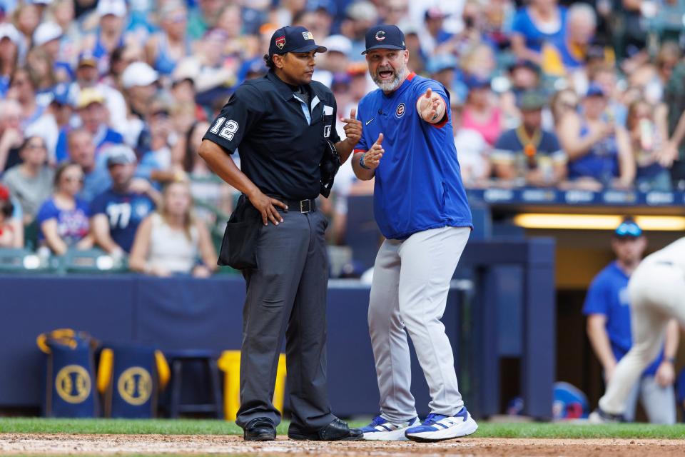 Chicago Cubs manager David Ross (right) argues a call with home plate umpire Erich Bacchus during the sixth inning against the Milwaukee Brewers at American Family Field. Ross was ejected in the 11th inning.