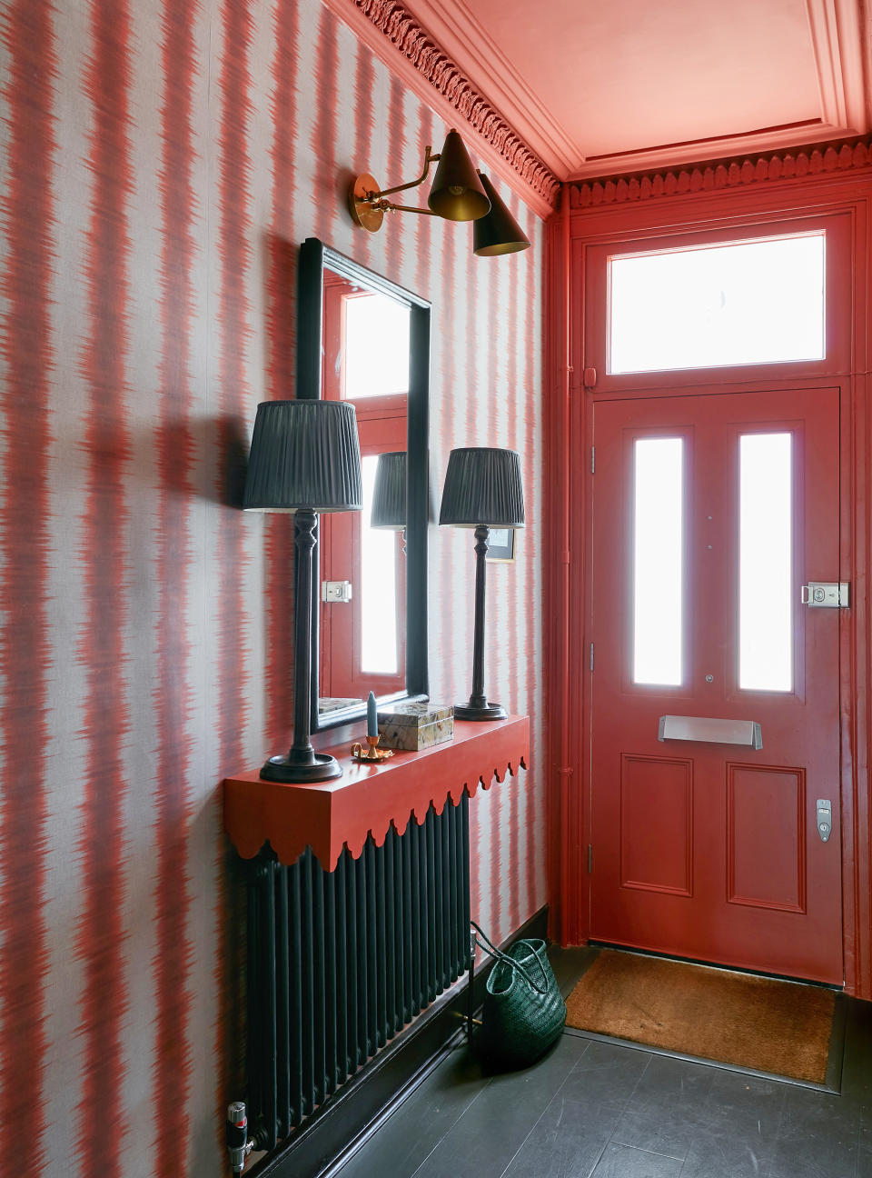 <p> &#x2018;The easiest way to make an impression in this previously dingy or small hallway was to add bold wallpaper,&#x2019; says interior decorator Laura Stephens. &#x2018;The cornice was very detailed and adding this flame red paint enhances it and works well with the stripe in the wallpaper.&#x2019; </p> <p> Interior designer Nina Campbell agrees: &apos;Decorating a hall is a lot of fun. It is a small space so you can be as wild as you like. I like to treat it like an exquisite jewelry box and paint the walls a wonderful color or put up a pretty hallway wallpaper.&apos; </p>