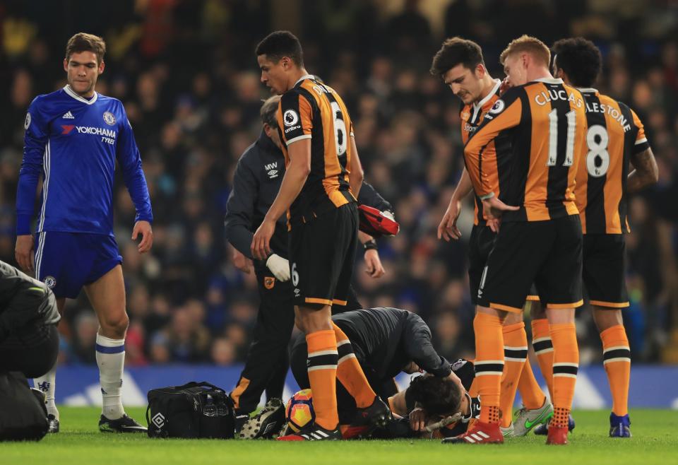 <p>Ryan Mason and Gary Cahill go down after a collision of heads </p>