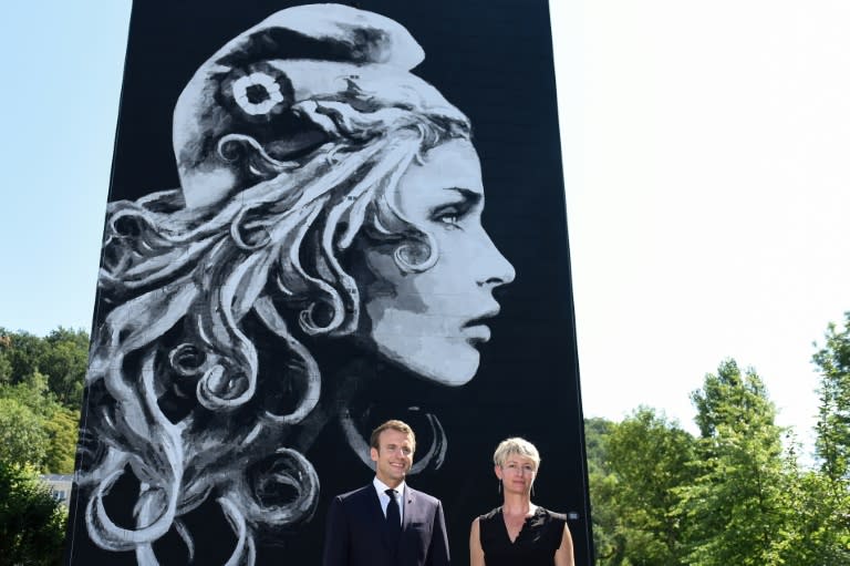 President Emmanuel Macron presented the new Marianne, France's revolutionary symbol, alongside its creator, the French-British street artist knonw as Yz, in Perigueux, southwest France, on Thursday