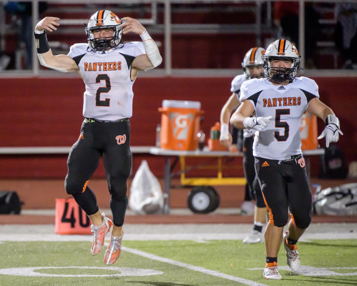 Washington's Kainon McQueary (2) and Elijah Baer celebrate their 42-21 victory over Morton for the Mid-Illini Conference championship Friday, Oct. 20, 2023 in Morton.