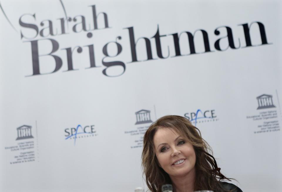 British singer Sarah Brightman smiles during news conference in Moscow, Russia, Wednesday, Oct. 10, 2012. Brightman is to become the first-ever global recording artist to take a spaceflight, teaming up with Space Adventures for a journey to the International Space Station (ISS). (AP Photo/Mikhail Metzel)