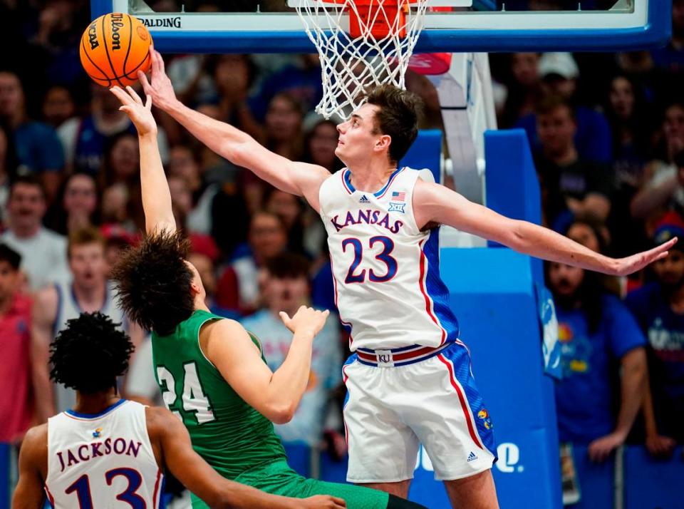 Kansas Jayhawks forward Parker Braun (No. 23) blocks the shot of Manhattan Jaspers forward Xinyi Li during Friday night’s game at Allen Fieldhouse.