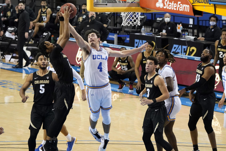 UCLA guard Jaime Jaquez Jr. (4) works for a rebound against Colorado guard Keeshawn Barthelemy, left, during the second half of an NCAA college basketball game Saturday, Jan. 2, 2021, in Los Angeles. (AP Photo/Marcio Jose Sanchez)