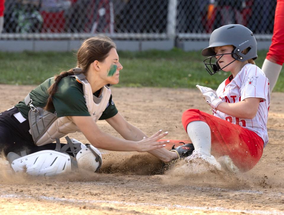 Canton South's Miley Spencer scores on Mentor Lake Catholic catcher Gia Mazzonlini in the third inning of Tuesday's tournament game.
