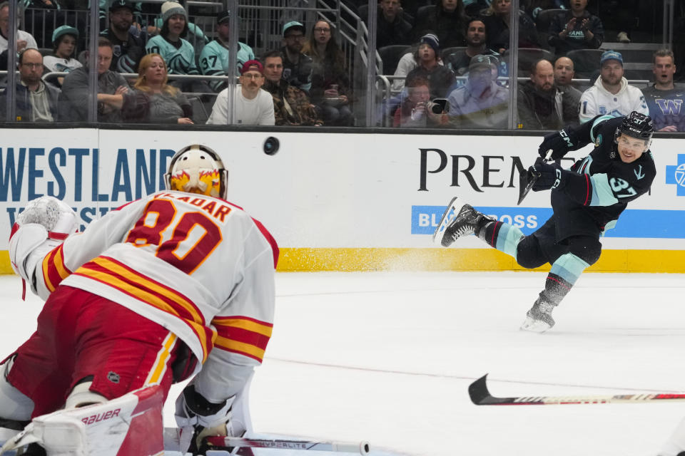 Seattle Kraken center Yanni Gourde shoots but Calgary Flames goaltender Dan Vladar (80) makes the save during the third period of an NHL hockey game Monday, Nov. 20, 2023, in Seattle. The Flames won 4-3 in overtime. (AP Photo/Lindsey Wasson)