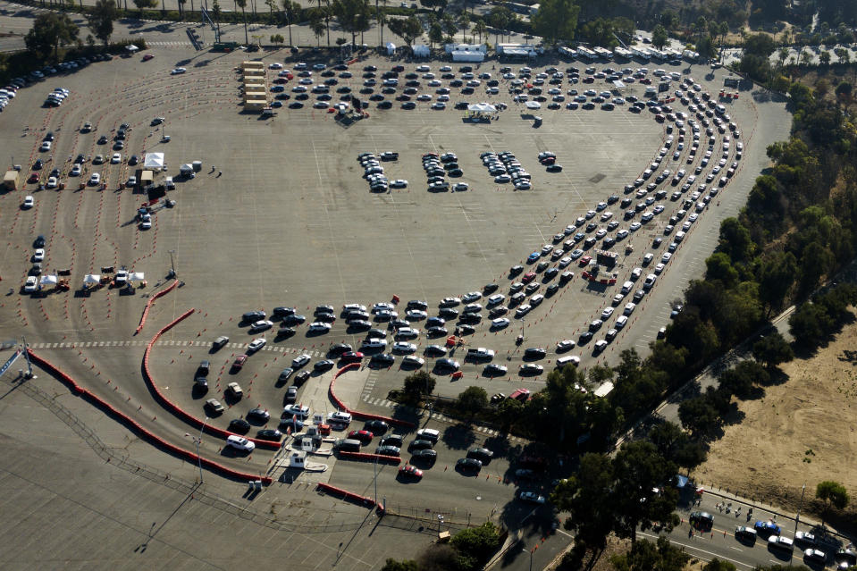 FILE - In this Nov. 18, 2020, file photo, long lines of motorists wait to take a coronavirus test in a parking lot at Dodger Stadium in Los Angeles. With the coronavirus surging out of control, the nation’s top public health agency advised Americans on Thursday, Nov. 19, not to travel for Thanksgiving and not to spend the holiday with people from outside their household. (AP Photo/Ringo H.W. Chiu, File)