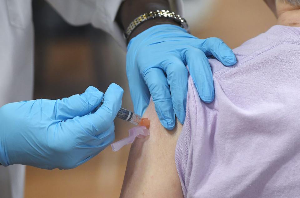 A flu shot is administered during a flu-shot clinic at the Zem Zem Shrine Club in Millcreek Township on Sept. 3, 2024.