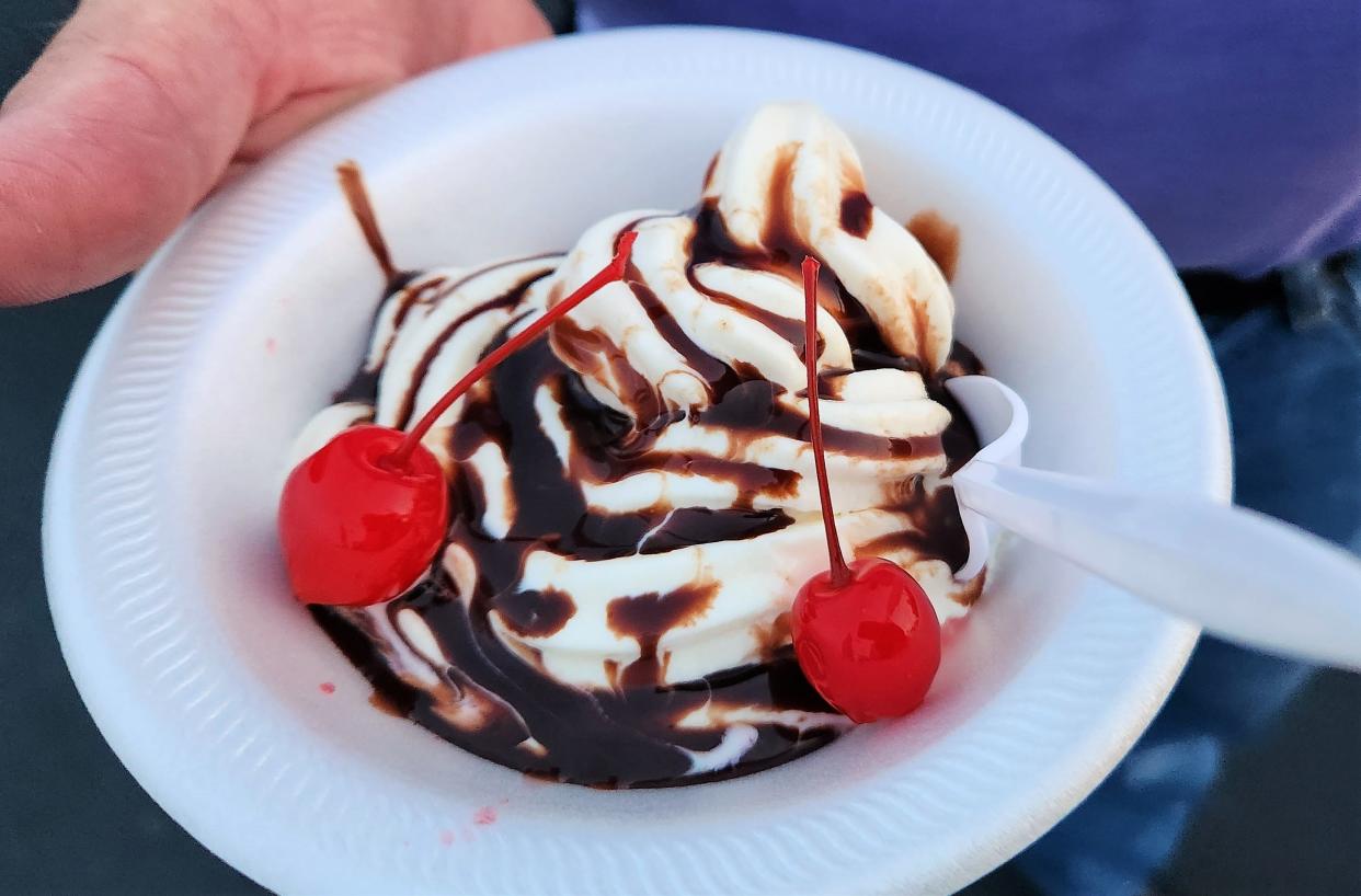 A sundae with ice cream, chocolate sauce and cherries is served with two cherries from the Old Fashioned Ice Cream and Concessions truck on Wednesday, Aug. 23, 2023. This is just one truck that will be in attendance at Track the Eclipse at Ellis Park on Monday, Apr. 8.