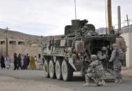 Soldiers from U.S. Army Alpha Company, 2-3 Inf, 3-2 SBCT, patrol a village with Afghan forces at the National Training Center in Fort Irwin, California, U.S. on August 13, 2011. Courtesy Ryan Hallock/U.S. Army/Handout via REUTERS