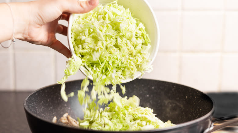 cabbage going into pan 