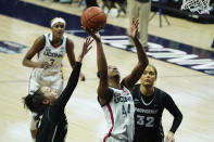 Connecticut forward Aubrey Griffin (44) shoots against Providence guard Kyra Spiwak, left, in the second half of an NCAA college basketball game at Harry A. Gampel Pavilion, Saturday, Jan. 9, 2021, in Storrs, Conn. (David Butler II/Pool Photo via AP)
